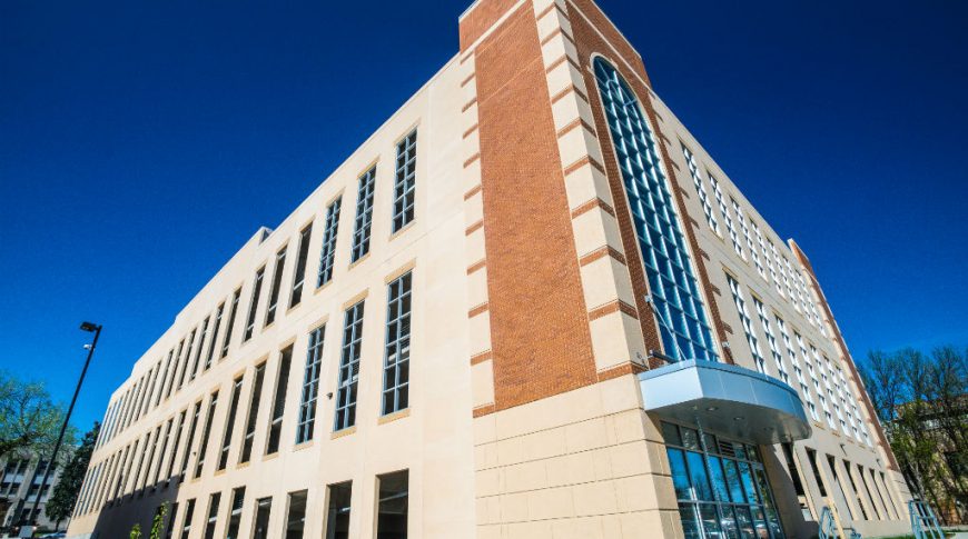 6th St. Parking Ramp-P-Ext4-1024x680-Government Construction Brick and concrete building with large tall windows and slight entryway awning over glass covered doors.