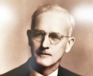 Black and white headshot photo of Clark Morrell Comstock who founded Comstock Construction in 1924