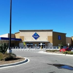 Further back view from parking lot of entrance to Sam's Club building.