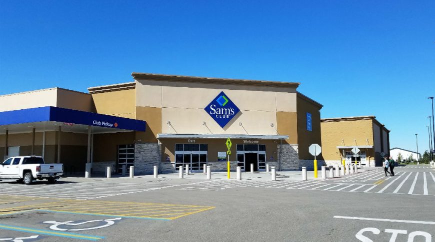 Front entrance view from the parking lot of Sam's Club beige building.