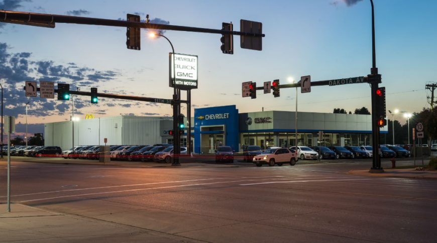 Kitty-corner street view of Smith Motors at dusk