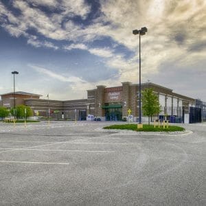 Brown brick exterior of Walmart building from Outdoor Living section of back parking lot