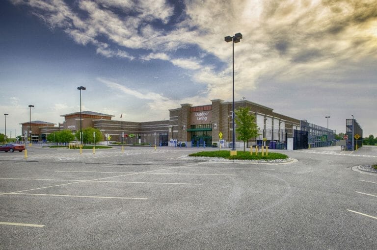 Brown brick exterior of Walmart building from Outdoor Living section of back parking lot