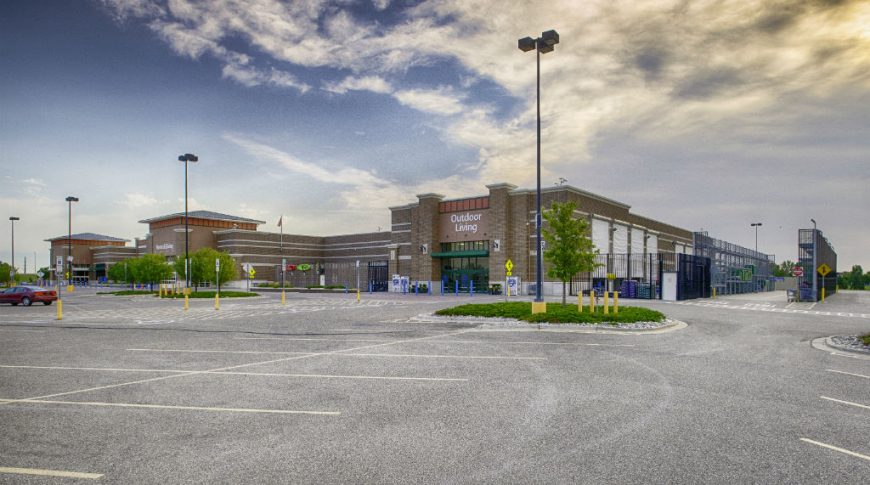 Brown brick exterior of Walmart building from Outdoor Living section of back parking lot