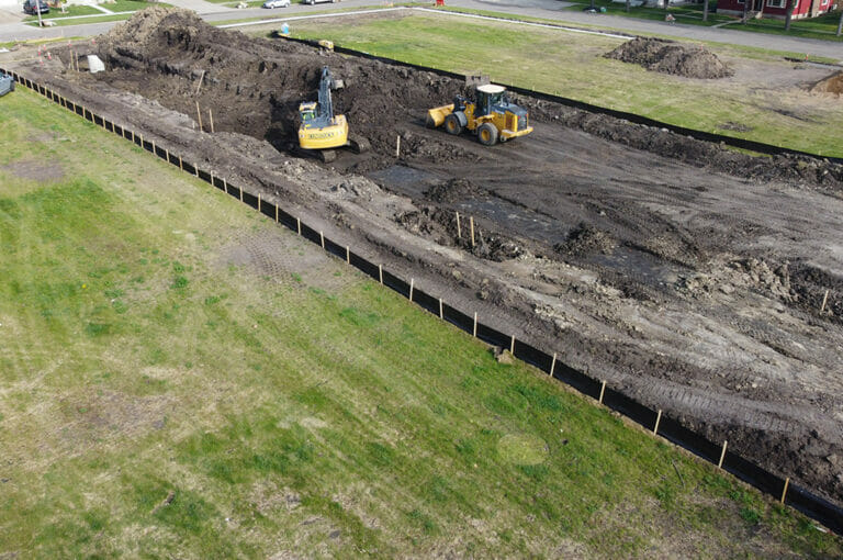 Central School Lot Redevelopment 2- Civil Construction Aerial view of construction Equipment digging on empty city lot
