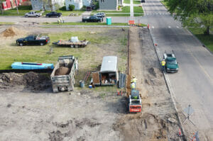 Aerial view of construction Equipment digging on empty city lot