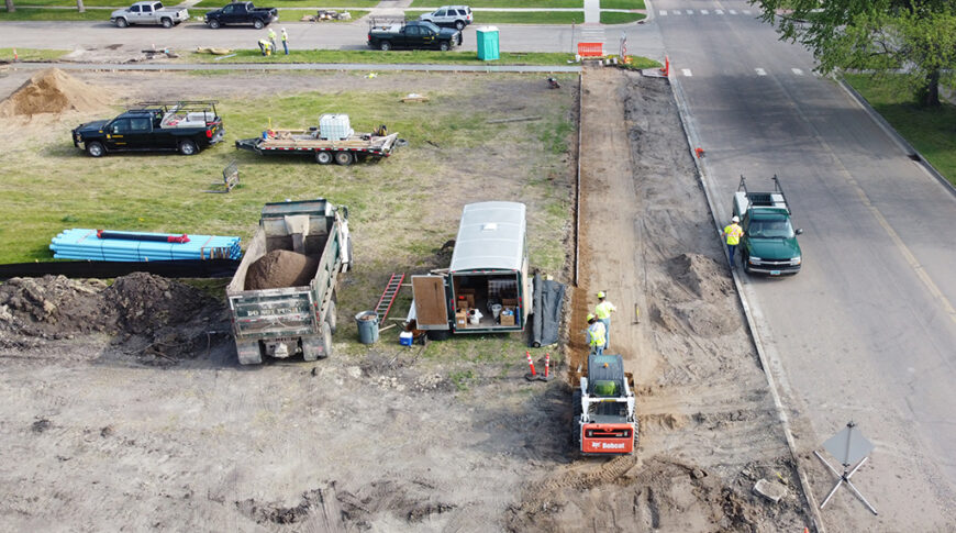 Aerial view of construction Equipment digging on empty city lot