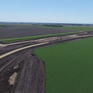 Aerial view of sitework for a new grain handling facility and rail loop track.