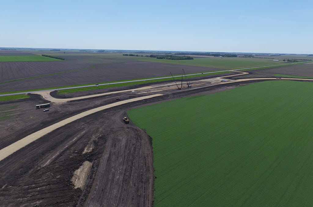 Aerial view of sitework for a new grain handling facility and rail loop track.