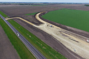 Aerial view of sitework for a new grain handling facility and rail loop track.
