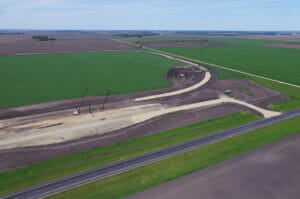 Aerial view of sitework for a new grain handling facility and rail loop track.