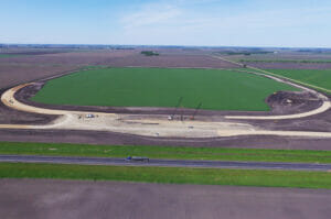 Aerial view of sitework for a new grain handling facility and rail loop track.