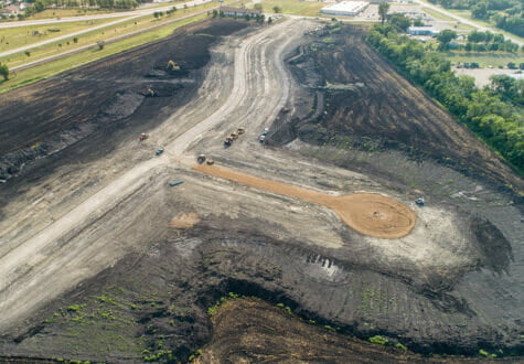 Aerial view of a residential development starting to take shape in a dirt field