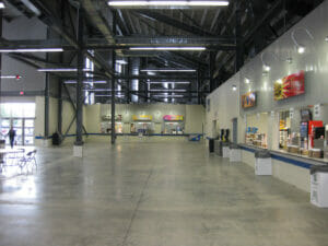 Concession stand covered area underneath North Dakota State Fair Grandstands with concrete floors and metal roof.