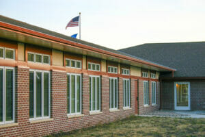 Exterior view of red-bricked Project Turnabout building with long tall windows spaced every few feet.