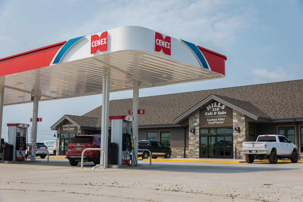 Exterior parking lot view of Cenex C-Store with iconic red, white, and blue cenex carport over gas stations and building in the background.