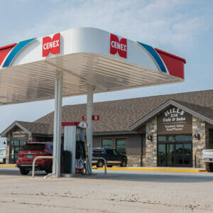 Exterior parking lot view of Cenex C-Store with iconic red, white, and blue cenex carport over gas stations and building in the background.