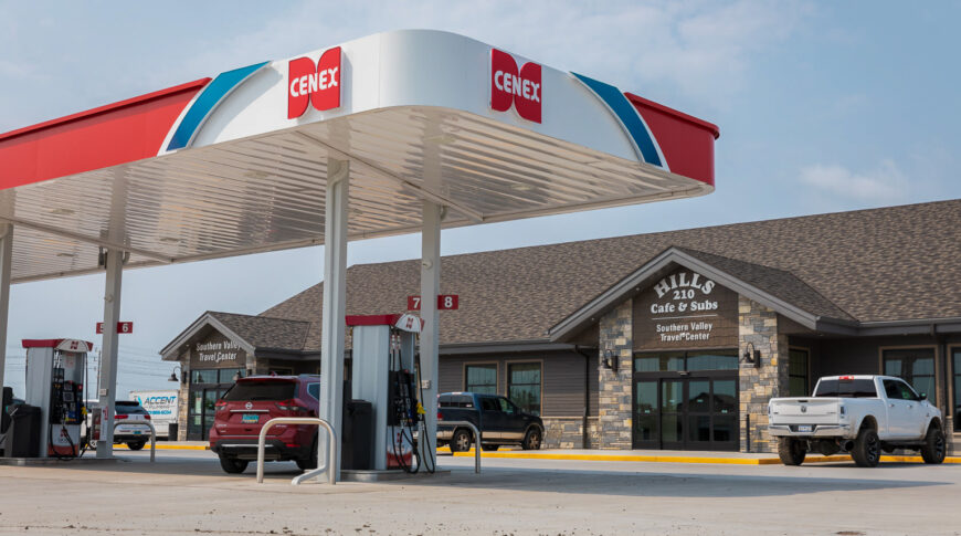 Exterior parking lot view of Cenex C-Store with iconic red, white, and blue cenex carport over gas stations and building in the background.