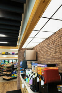 Smoothie and pop station at a Cenex C-Store with bright fascia lighting and brick backsplash.