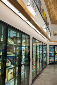 Frozen foot coolers at the back of a Cenex C-Store in Wahpeton with frozen pizzas and chilled beverages.