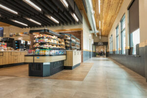 Low viewpoint at the entrance of Cenex C-Store looking into aisles of the premade sandwiches and juice and coffee bar to the back.