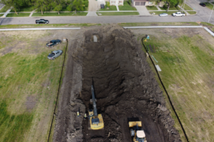 Excavator and bulldozer work to prep the ground at a school redevelopment site.