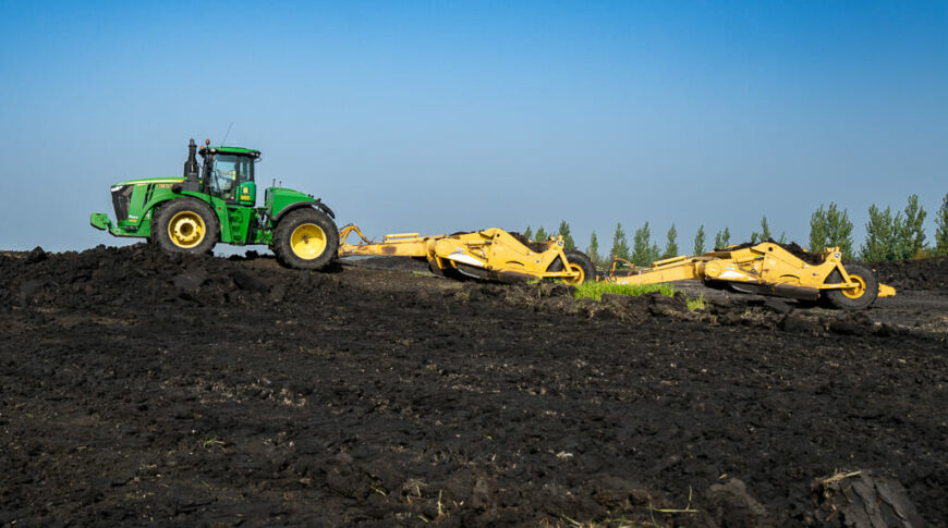 City of Horace-Civil Construction-Low Res-28 Green tractor with yellow grading and excavating tool doing the earthwork for the Rivers Edge Second Addition development.
