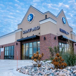 Exterior view of Sanford Horace Clinic with red brick facade and tall windows.