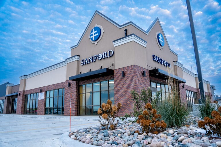 Exterior view of Sanford Clinic in Horace with red brick facade and tall windows.