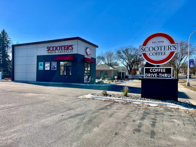 Exterior view of Scooter's Coffee sign and building from the parking lot during late fall.