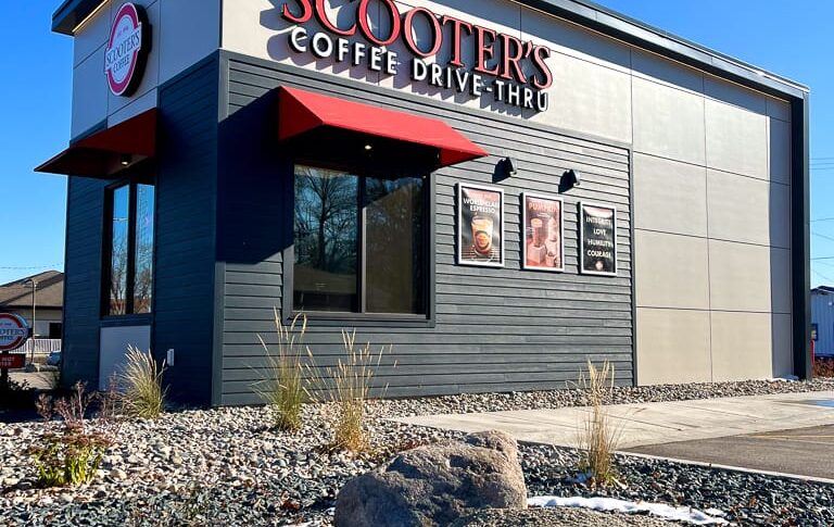 View off coffee drive-thru building taken from a low angle in the surrounding rock and shrubbery accent beds.