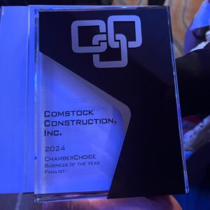 Image of a clear resin plaque that says "Comstock Construction, Inc. 2024 Chamber Choice Business of the Year Finalist."