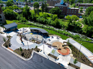 Aerial drone view from parking lot of the Fergus Falls Riverfront Splash Pad with the Otter Tail river in the background.