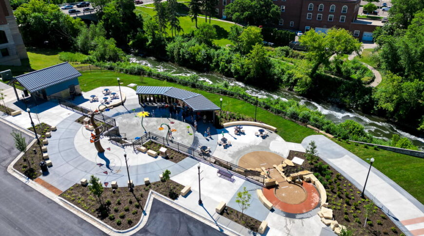 Aerial drone view from parking lot of the Fergus Falls Riverfront Splash Pad with the Otter Tail river in the background.
