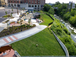 Aerial drone view from the west side of the Fergus Falls Riverfront Splash Pad with the Otter Tail river in the background.