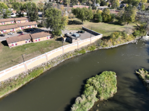Bank of the Sheyenne river just downstream the Valley City Little Dam before dam removal. Shows the flood wall to one side of the bank.