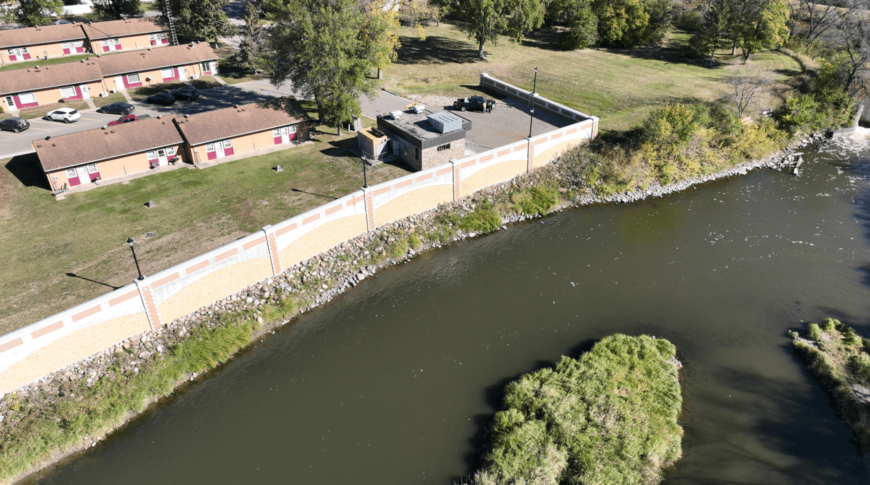 Bank of the Sheyenne river just downstream the Valley City Little Dam before dam removal. Shows the flood wall to one side of the bank.