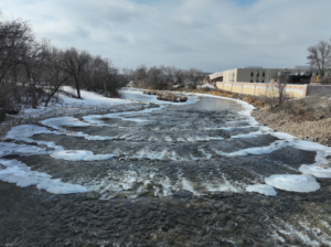 Slightly aerial view looking at the rows of rock weirs newly placed after dam demolition along the Sheyenne river in Valley City, ND.
