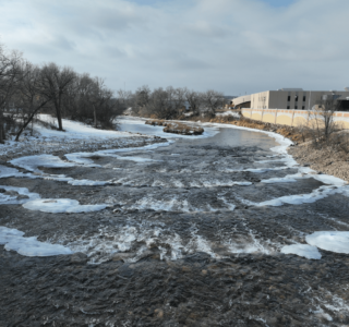 Slightly aerial view looking at the rows of rock weirs newly placed after dam demolition along the Sheyenne river in Valley City, ND.