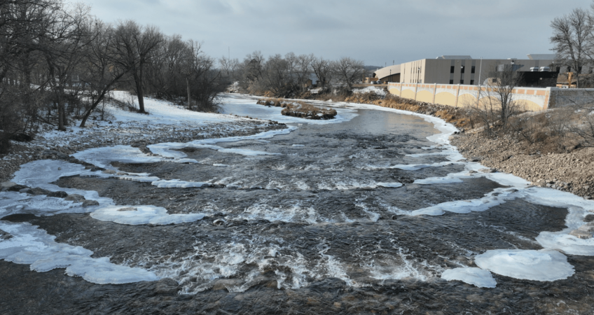Slightly aerial view looking at the rows of rock weirs newly placed after dam demolition along the Sheyenne river in Valley City, ND.
