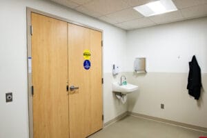 Medical area with double doors in the middle, sink station on the right.