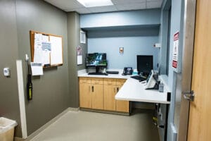 Control room of Marshall County Healthcare MRI with l-shaped countertops with two computer workstations.