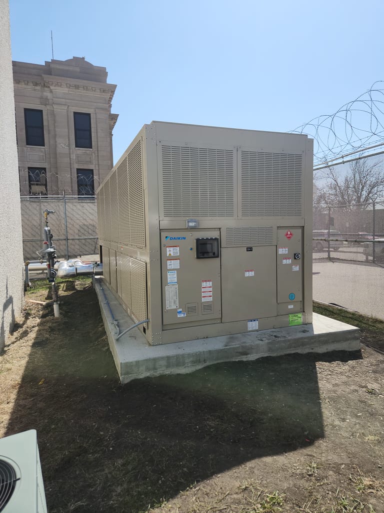 Daikin chiller unit on concrete block outside next to the Richland County Courthouse.