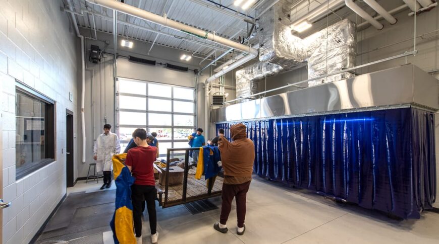 Dunseith CTE students dawning work shirts to get hands-on experience in specialty lab. Photo by Icon Architectural Group.