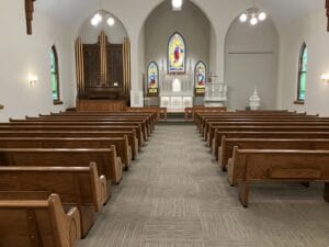 Forward looking view of church pulpit after the refresh, with new carpeting and paint.