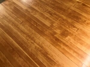 Close up view of refinished hardwood flooring on the pulpit area of Hankinson's Immanuel Lutheran Church.