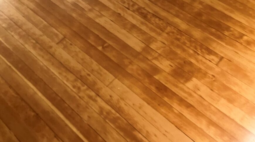 Close up view of refinished hardwood flooring on the pulpit area of Hankinson's Immanuel Lutheran Church.