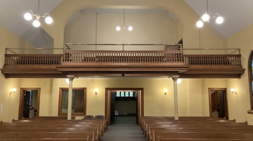 Prior to remodel view of the back of the church looking out into the pews and choir loft.