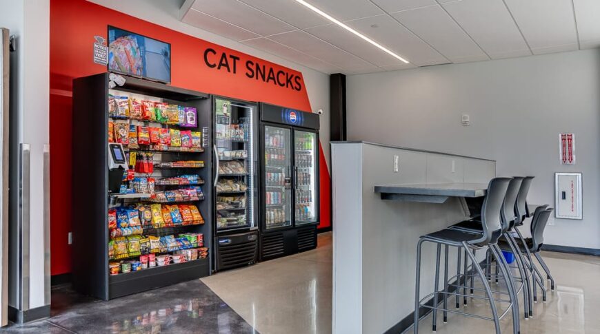 "Cat Snacks" vending area at the college commons room with bar height half wall countertop and chairs besides.