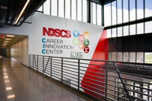 Second story view of the reception area with floor to ceiling windows and a sign that reads "NDSCS Career Innovation Center."